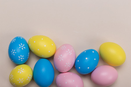 Colorfull easter eggs in nest on pastel color background with space. Conceptの写真素材