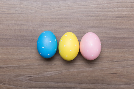 Easter eggs on wooden table. Holiday backgroundの写真素材