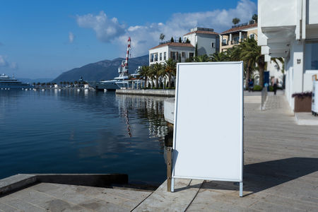 Blank white outdoor advertising stand, sandwich board mock up template. Clear street signage board placed inside modern building. Urban city, shopping center environmentの写真素材