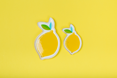 limon plate on yellow background. conceptの写真素材
