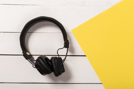 Headphones  on wooden background.Trendy colorful photo. Minimal style with colorful paper backdrop. Music conceptの写真素材