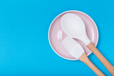 kitchen utensils on a saucer on blue backgroundの写真素材