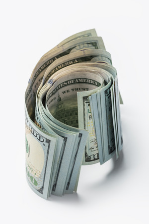 Stack of hundred crumpled dollars isolated on whiteの写真素材