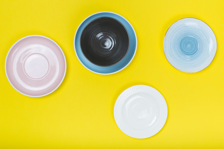kitchen utensils, Clean  porcelain dishes on yellow  background. Top viewの写真素材