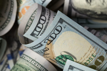 American dollars. A stack of hundred dollar bills. Close up of new hundred dollar bill on the white background.の写真素材
