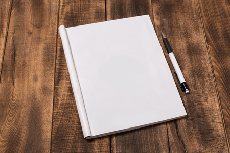 Mock-up magazine or catalog on wooden table. Blank page or notepad on wood background. Blank page or notepad for mockups or simulationsの写真素材