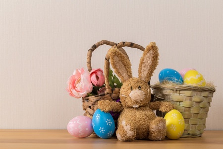 Easter bunny rabbit with  painted egg on wooden background. Easter holiday concept.の写真素材