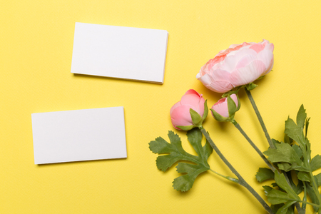 Blank white business cards on yellow background. Mockup for branding identity. Template for graphic designers portfolios. Top view.の写真素材