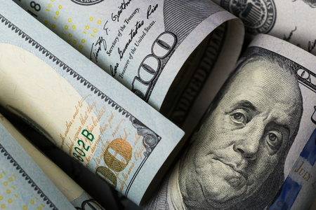 American dollars. A stack of hundred dollar bills. Close up of new hundred dollar bill on the white background.の写真素材