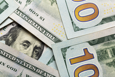 American dollars. A stack of hundred dollar bills. Close up of new hundred dollar bill on the white background.の写真素材