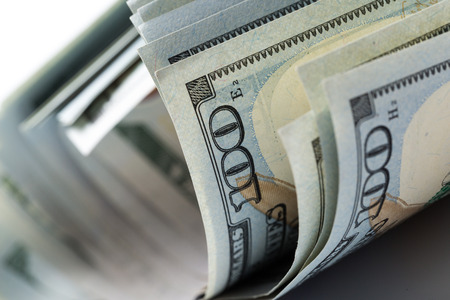 Stack of hundred crumpled dollars isolated on whiteの写真素材