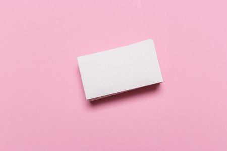 Blank white business cards on pink background. Mockup for branding identity. Template for graphic designers portfolios. Top view.の写真素材