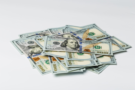 Many bundle of US 100 dollars bank notes isolated on white backgroundの写真素材