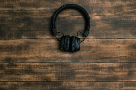 Headphones on dark wooden background. Vintage styleの写真素材
