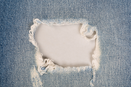 White stitching on blue denim jeans patch. Close up blue jean frameの写真素材