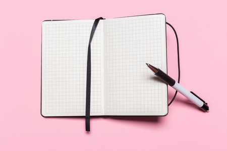 school notebook on a pink background, notepad on a table.Top viewの写真素材