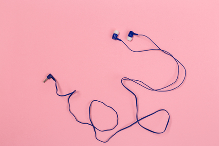 Headphones on pastel background. White headphones on a pink background. Top view. Flat lay. Copy space. Trendy colorful photo. Minimal style with colorful paper backdrop. Music conceptの写真素材