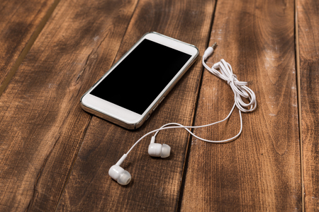 white phone on wood blank space.Top viewの写真素材
