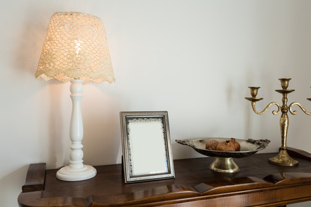 retro decor, lamp and photo frame on the dresser. Vintageの写真素材