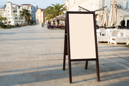 Blank white outdoor advertising stand, sandwich board mock up template. Clear street signage board placed inside modern building. Urban city, shopping center environmentの写真素材