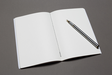 top view of a open notebook with pencil on a gray background. Office notepad flat layの写真素材