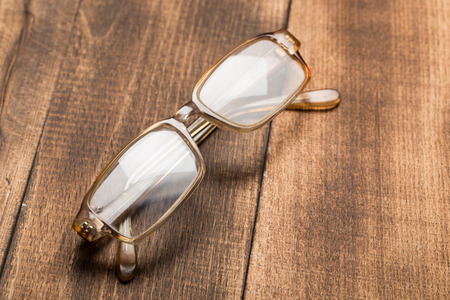 A pair of glasses on a wooden tableの写真素材