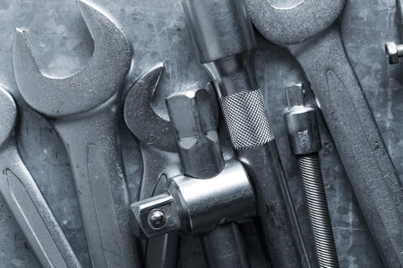 old wrench and tools and Engine spare parts on rusty backgroundの写真素材