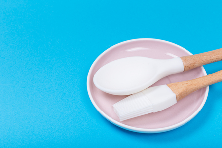 kitchen utensils on a saucer on blue backgroundの写真素材