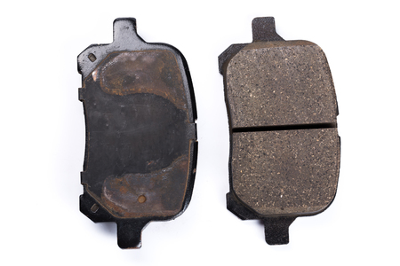 Set of old brake pads, car spares isolated on white backgroundの写真素材
