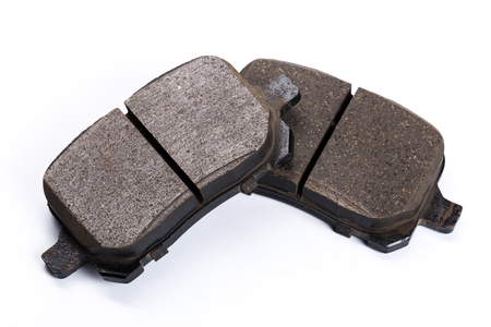 Set of old brake pads, car spares isolated on white backgroundの写真素材