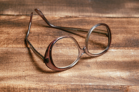 A pair of glasses on a wooden tableの写真素材