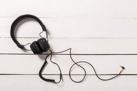 black Headphones on white wooden backgroundの写真素材
