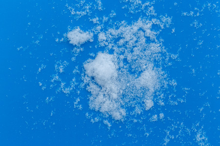 White snowy fields under a blue background. Snow texture Top view of the snow.の写真素材