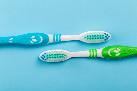 Two new toothbrush on a blue background. Dental conceptの写真素材