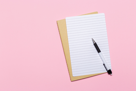 school notebook on a pink background, notepad on a table.Top viewの写真素材