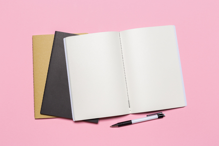 school notebook on a pink background, notepad on a table.Top viewの写真素材