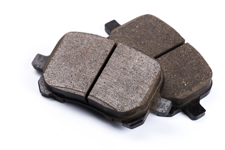 Set of old brake pads, car spares isolated on white backgroundの写真素材