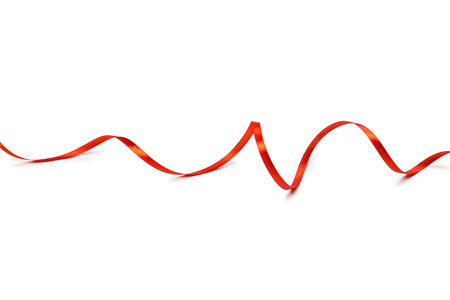 Red satin ribbon isolated on white backgroungの写真素材