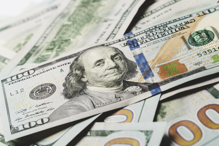 American dollars. A stack of hundred dollar bills. Close up of new hundred dollar bill on the white background.の写真素材