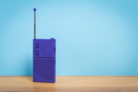 Vintage old radio on wooden table with color wall backgroundの写真素材