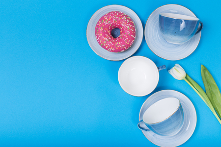 Empty plates and bowls on blue wooden background. Retro toned. Top view with copy spaceの写真素材