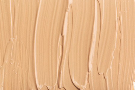 Close up of smear beige and ligth pink tone foundation texture for background.の写真素材