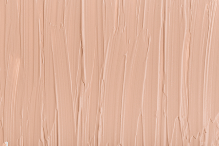 Close up of smear beige and ligth pink tone foundation texture for background.の写真素材