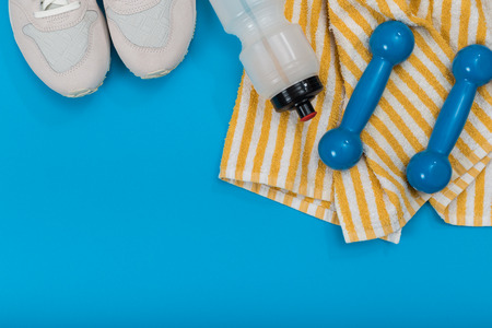 Sport equipment on blue background, top view. Concept healthy lifestyle, healthy food, sport and diet.の写真素材