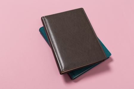 top view of a open notebook on a pink background. Office notepad flat layの写真素材