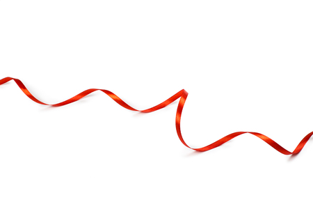 Red satin ribbon isolated on white backgroungの写真素材