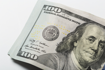 American dollars. A stack of hundred dollar bills. Close up of new hundred dollar bill on the white background.の写真素材