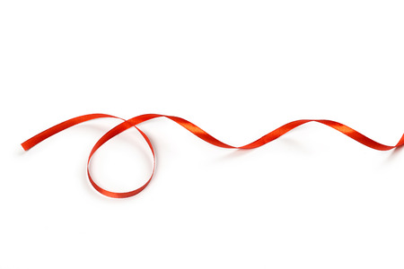 Red satin ribbon isolated on white backgroungの写真素材