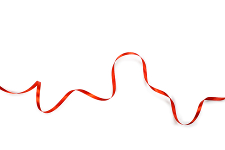 Red satin ribbon isolated on white backgroungの写真素材