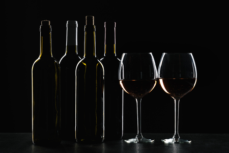 Bar Concept with a Wine Bottle, a Wine Glass and a Cocktail on a Black Backgroundの写真素材